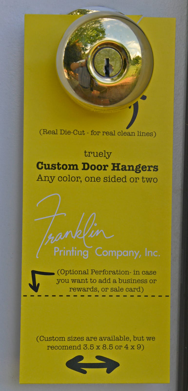 Die-cut Franklin Printing door hanger hanging on a front-door knob