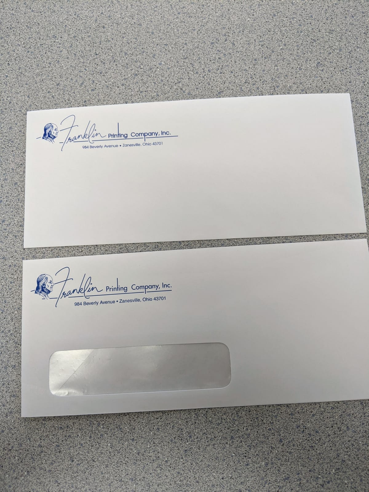 Two #10 Franklin Printing envelopes, one plain and one with a window